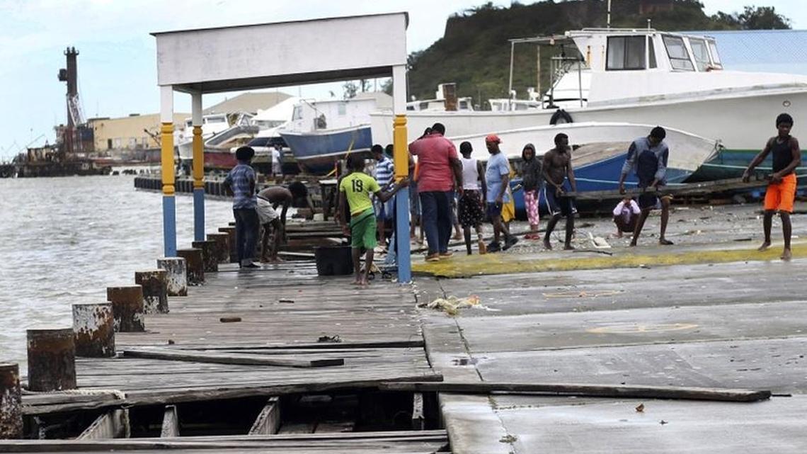 Locals recover part of a dock in St. John’s, Antigua and Barbuda, after Hurricane Irma departed.