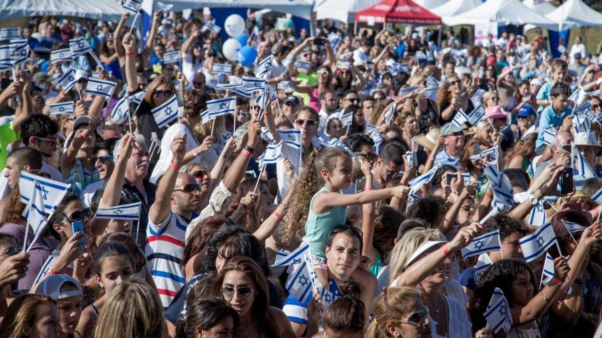 Visitors wave Israeli flags during the Create Israel Festival in May 2015. More than 10,000 people are expected to attend this year’s festival at C.B. Smith Park in Pembroke Pines.