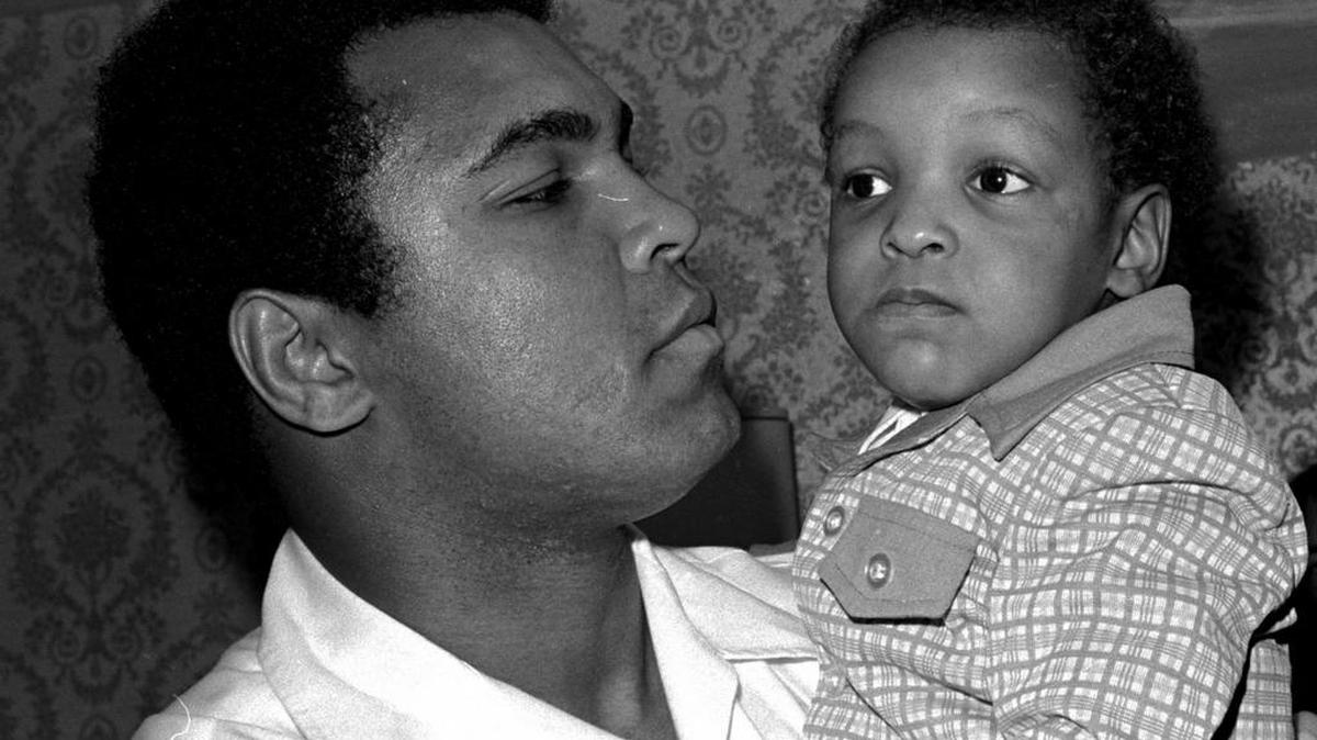 In this April 15, 1975 file photo, Heavyweight boxing champion Muhammad Ali, and Little Muhammad Ali, his then 2 1/2 year old son, arrive at Miami Beach. Ali Jr., 44, was detained by immigration officials at Fort Lauderdale-Hollywood International Airport and questioned about his ancestry and religion in what amounted to unconstitutional profiling, a family friend said Saturday.