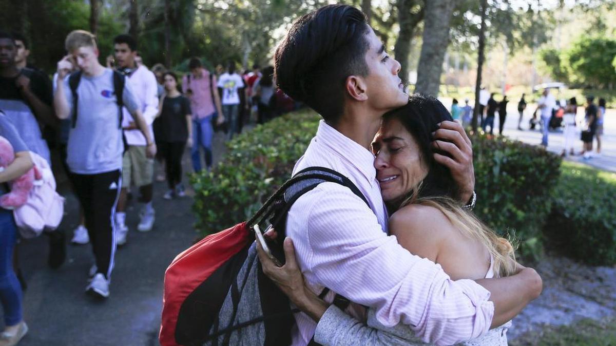 After a gunman opens fire on campus, Jorge Zapata, 16, a Sophmore, hugs his mother Lavinia Zapata outside Marjory Stoneman Douglas High School on Wed., Feb. 14, 2018.