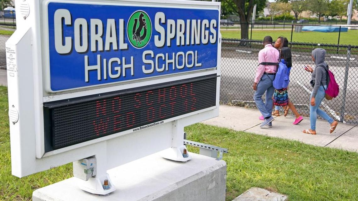 Students leave Coral Springs High School on Monday, Oct. 10, 2016. Coral Springs Police Sgt. Carla Kmiotek said two students reportedly saw a former student with a gun in his waistband in the parking lot of the school just before 1 p.m. The school was put on lockdown and the suspect was later found by police in the school's cafeteria and detained along with two current students. On Tuesday morning another student was arrested after he posted a threatening message on Instagram, police say.