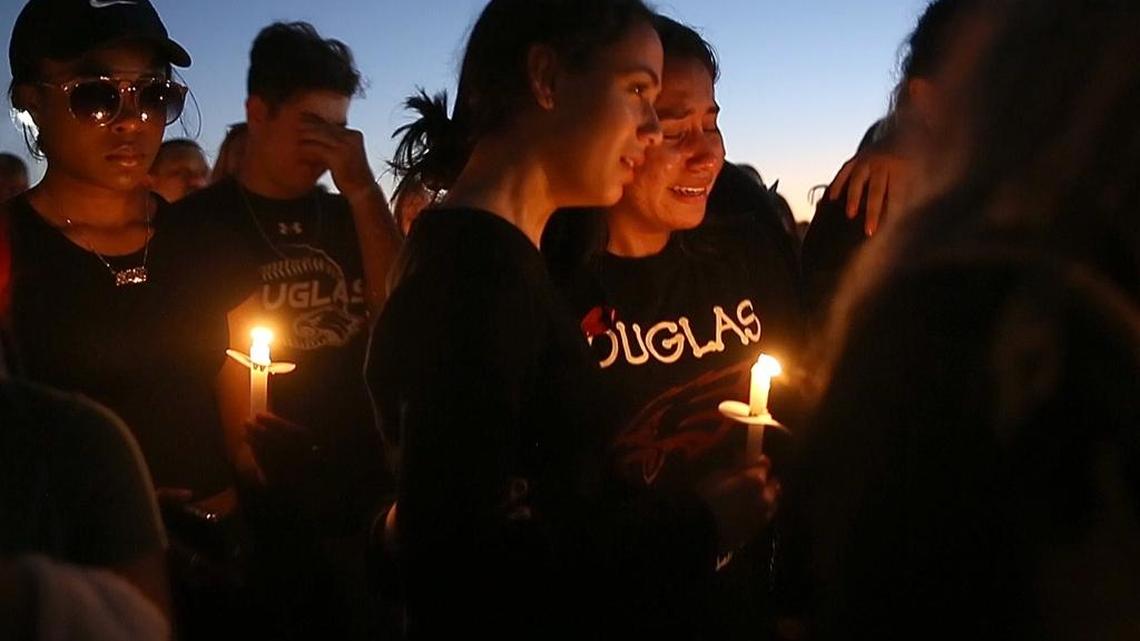 Mourners lit candles during a vigil for the shooting victims at Marjory Stoneman Douglas High School at Pine Trails Park in Parkland on Thursday, Feb. 15, 2018.