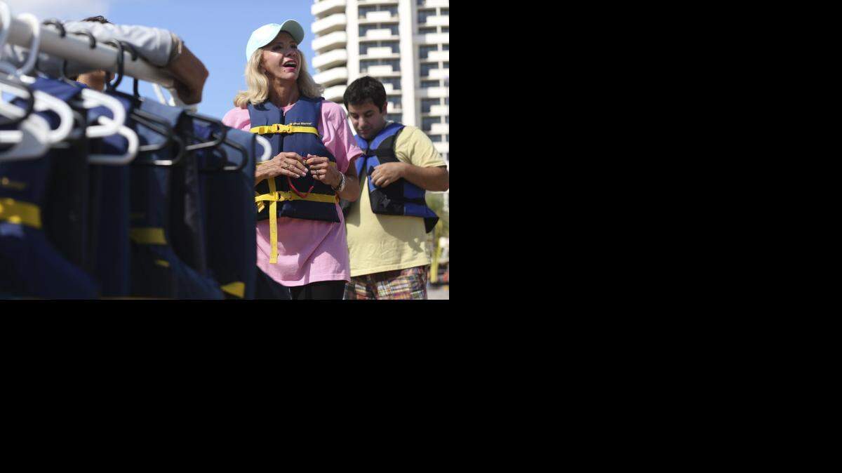 
Senator Maria Sachs suits up in a life vest prior to her parasailing flight. Sachs took to the air to honor the passing of the White-Miskell Act at Aloha Watersports in Fort Lauderdale on Thursday, Oct. 2, 2014.
