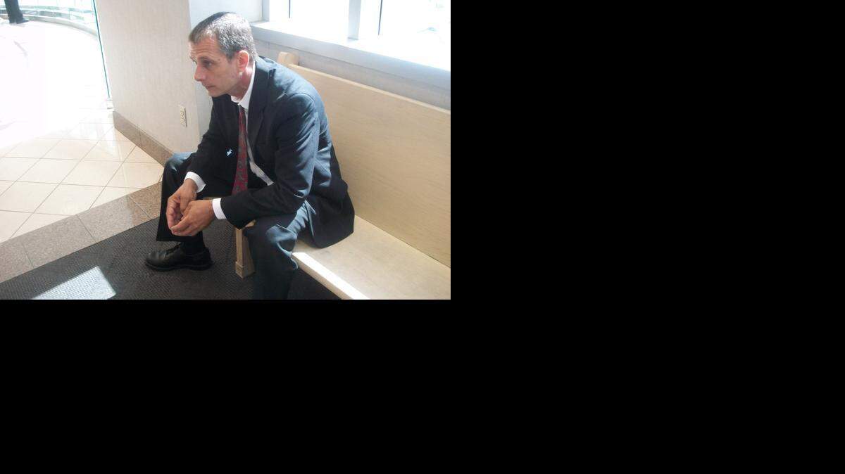 
Jesse Teplicki waits outside a Broward County courtroom. Teplicki, 51, says he grows marijuana at his Hollywood home for his own medicinal purposes, not to sell to others. 
