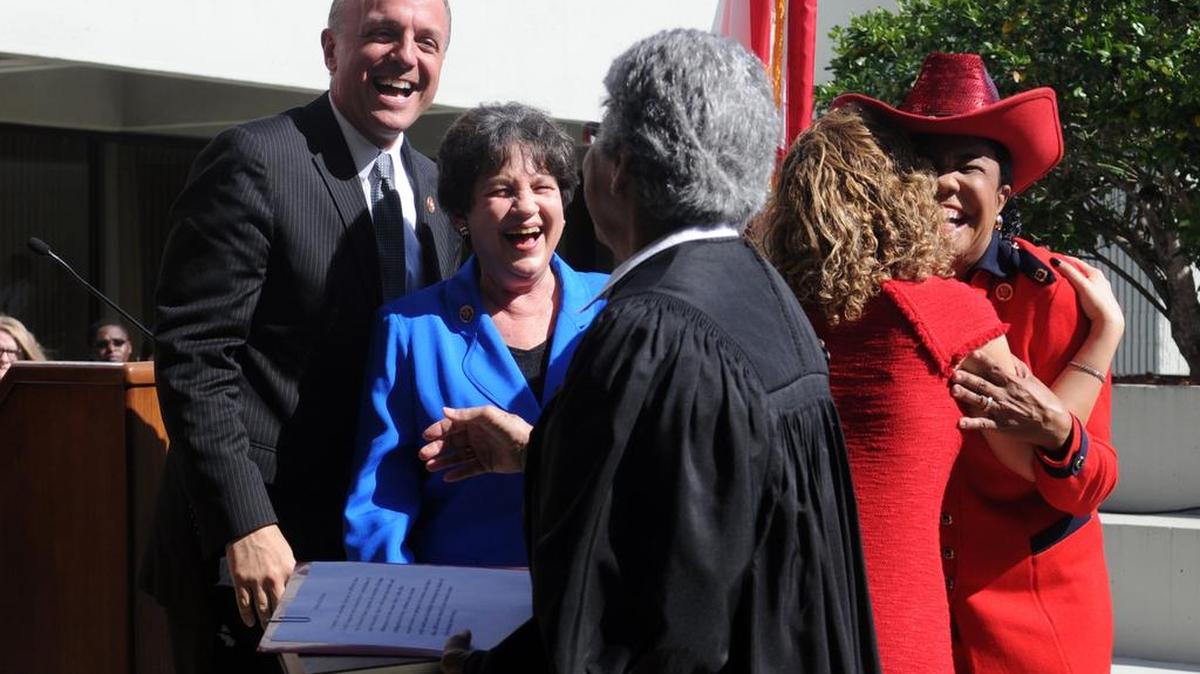
U.S. Representatives (left to right, background) Ted Deutch (Broward/Palm Beach), Lois Frankel (Broward/Palm Beach), Debbie Wasserman Schultz (Broward/Miami-Dade) and Frederica Wilson (Broward/Miami-Dade) were all smiles and hugs after being sworn in by Judge Rosemary Barkett (foreground) Jan. 14, 2013, at the Federal Courthouse in Fort Lauderdale. 
