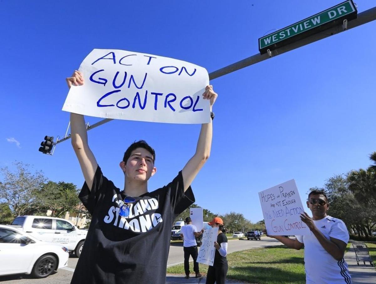 Josh Levine, 17, a student from Marjory Stoneman Douglas High School, stands at the corner of Westview Drive and University Drive, protesting for tighter gun control on Friday, Feb. 16, 2018.
