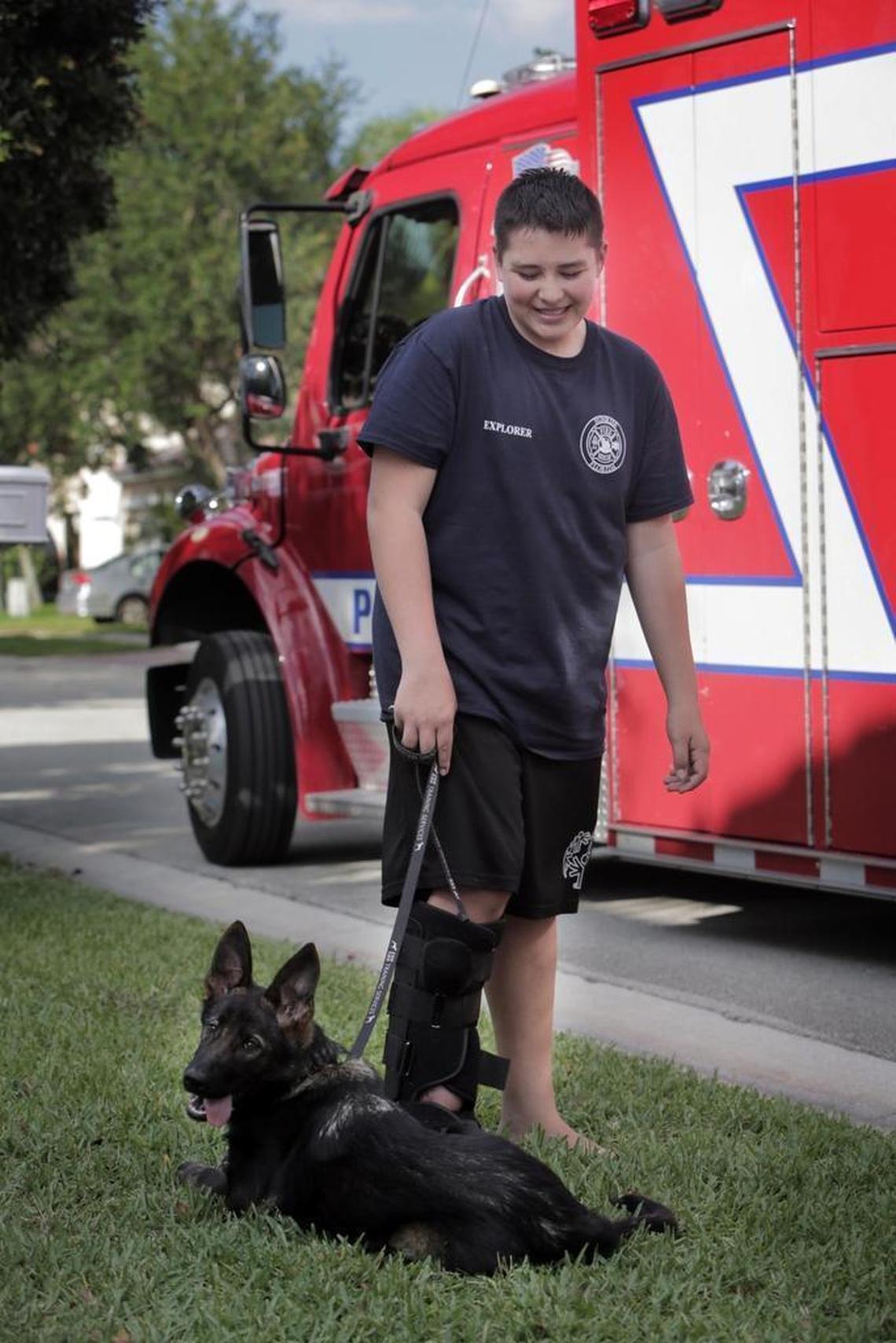 Kyle Laman and his dog Bruce hang around with the Coral Springs Parkland Fire Rescue during a visit on April 25.