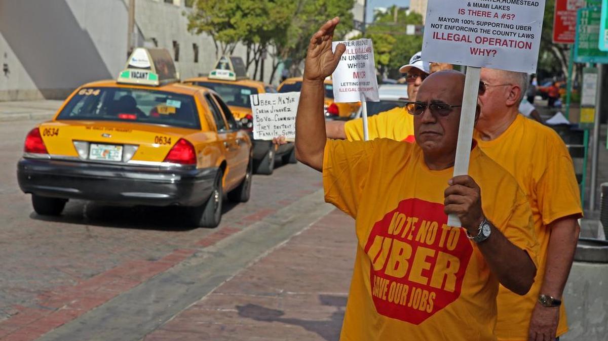 
 Shalom Hamami, a taxi driver and owner in Broward and Miami-Dade, protests Uber’s continuing presence in Dade at the County Hall Tuesday June 30, 2015. 
