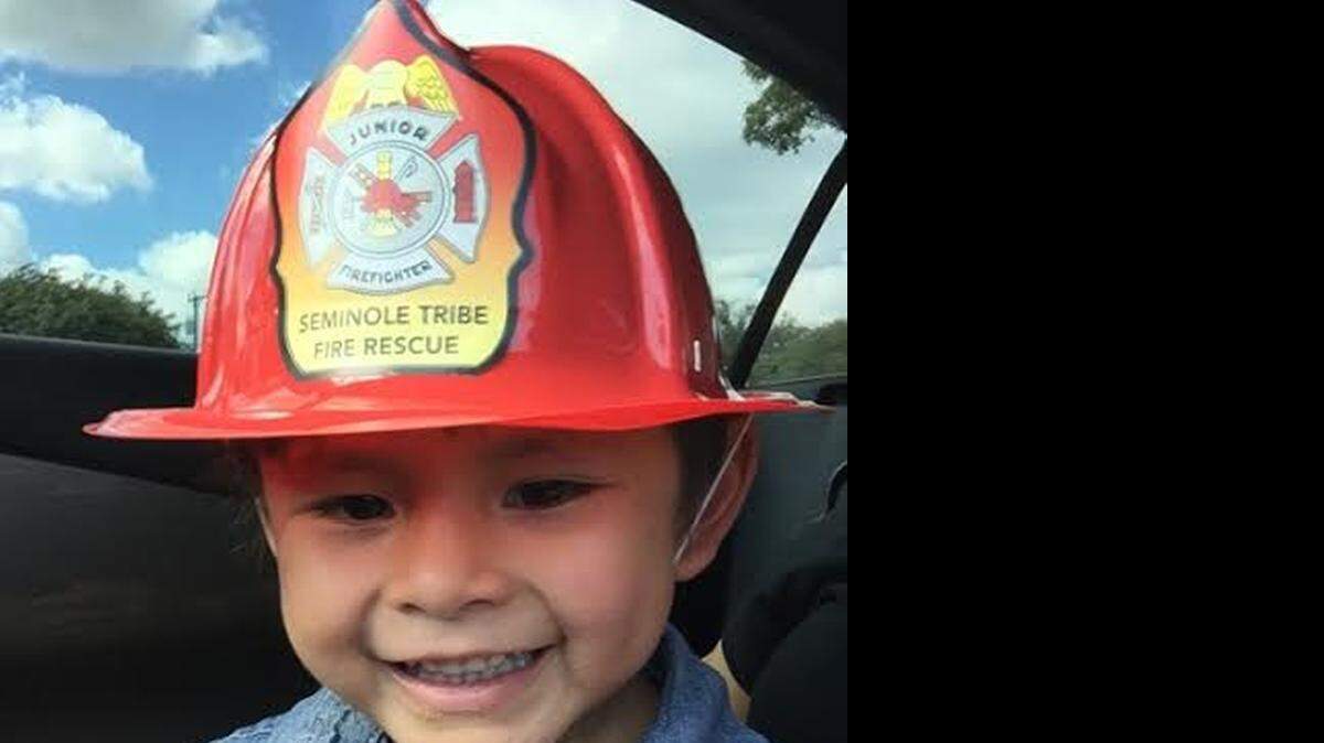 
Ahziya Osceola, 3, wears a fireman’s helmet only months before he was killed.
