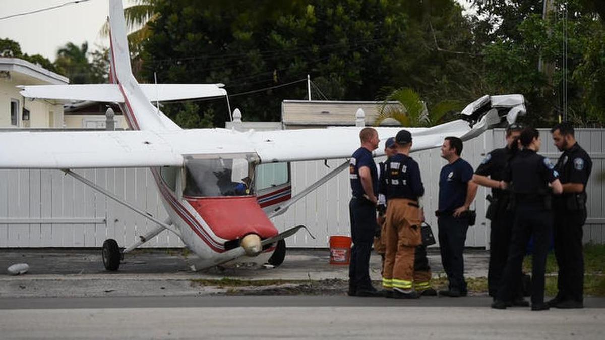 Hollywood emergency officers investigate the landing of a small plane that landed in the driveway of a home.