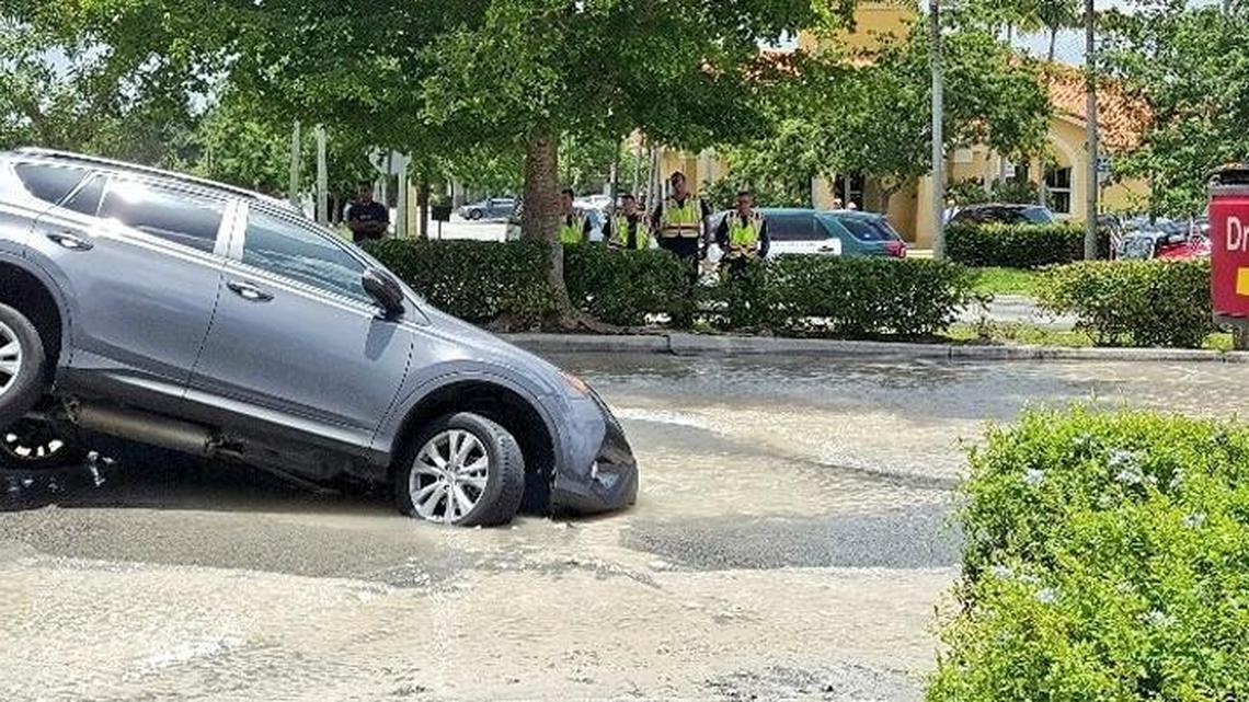 A Toyota SUV fell into a sinkhole near the drive-thru at the McDonald’s located at 10260 Griffin Rd. in the Pine Lake Plaza on Thursday.