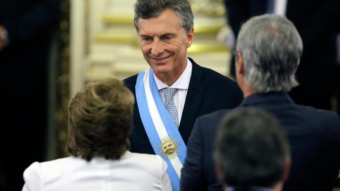 Argentina's President Mauricio Macri, top, shakes hands with Chile's President Michelle Bachelet, bottom left, after receiving the presidential sash from acting Senate President Federico Pinedo at the government house in Buenos Aires, Argentina, Thursday, Dec. 10, 2015. Macri, the former mayor of Buenos Aires who hails from one of Argentina's richest families, took the oath of office in Congress in front of legislators, several Latin American heads of state and other dignitaries.