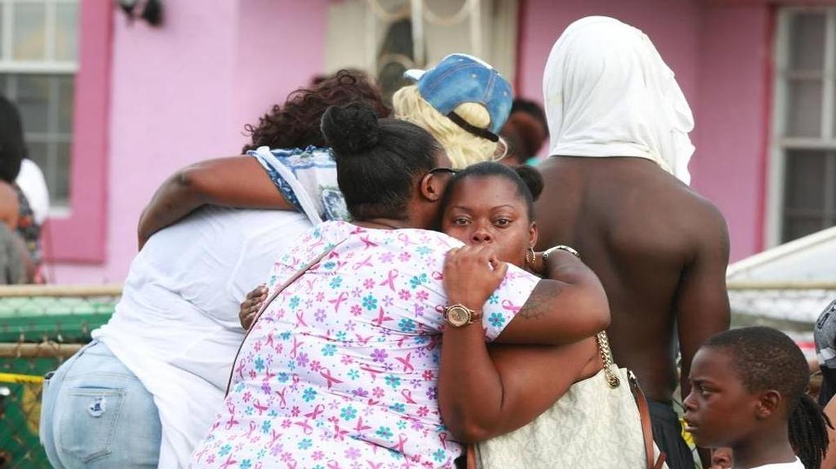 Mourners gathered outside a Lauderhill home on Monday after three bodies were found inside.