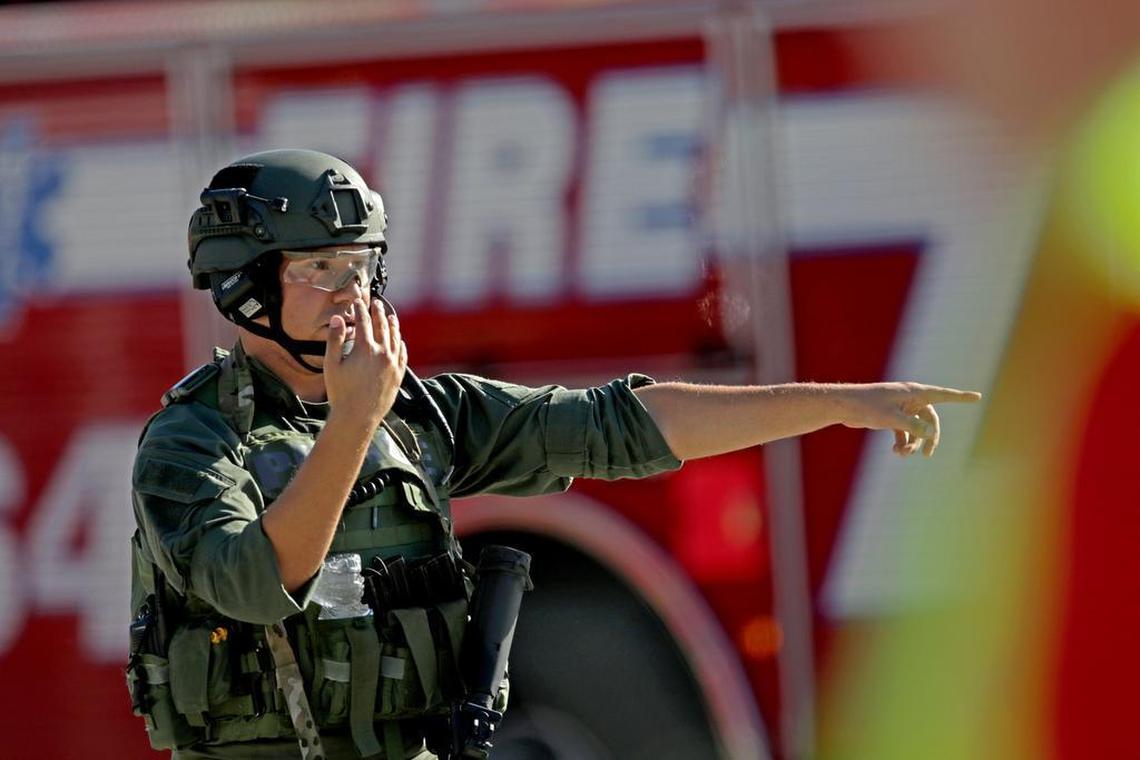 A law enforcement officer directs traffic outside of Stoneman Douglas High School in Parkland after reports of an active shooter on Wednesday, Feb. 14, 2018.