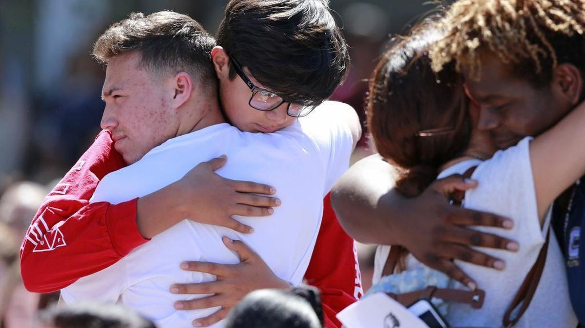 Attendees comfort each other at a community prayer vigil at Parkridge Church for shooting victims from Marjory Stoneman Douglas High School on Thursday, Feb. 15, 2018.