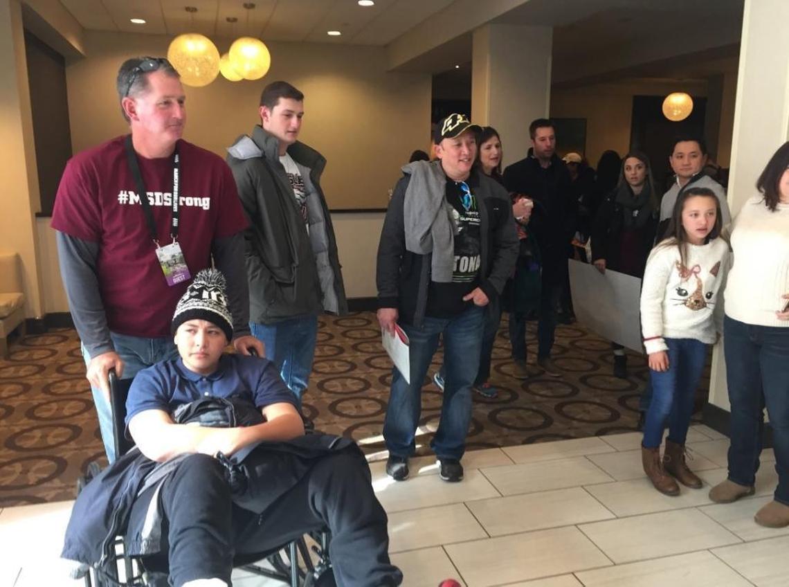 Sgt. Jeff Heinrich, with Coral Springs Police Department, pushes 15-year-old MSD shooting survivor Kyle Laman at the March For Our Lives rally in Washington D.C. in late March.