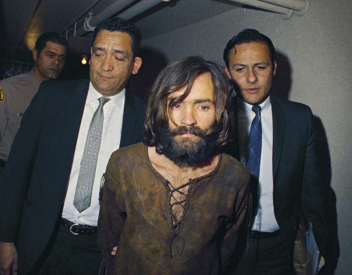 Charles Manson is escorted to his arraignment in 1969 on conspiracy-murder charges in connection with the Sharon Tate murder case. Manson died in 2017 at 83 but received fan letters and marriage proposals ever since his 1971 conviction in a California court for his role in the Helter Skelter murders.