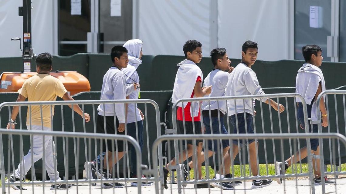 Migrant children are escorted throughout the Homestead Temporary Shelter for Unaccompanied Children during Good Friday in Homestead on April 19, 2019.