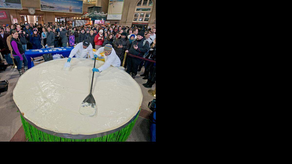 
Florida Keys chefs David Sloan, left, and Marky Pierson, right, finish preparing a giant Key lime pie Thursday at South Station in Boston as part of an advertising campaign for the Florida Keys.
