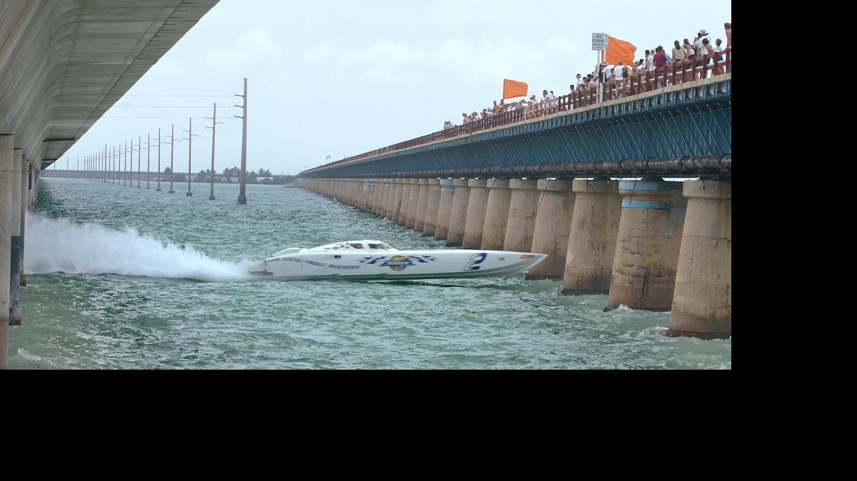 
A racing boat speeds between new, left, and old Seven Mile Bridges in the Florida Keys enroute to victory in the Superboat Unlimited Class in 2002. at the Marathon Super Boat Grand Prix.
