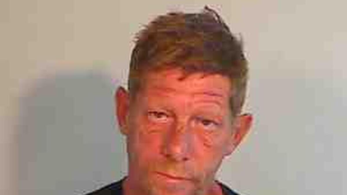 Craig Dieter poses as his brother Christopher in this March mug shot after an arrest for battery.