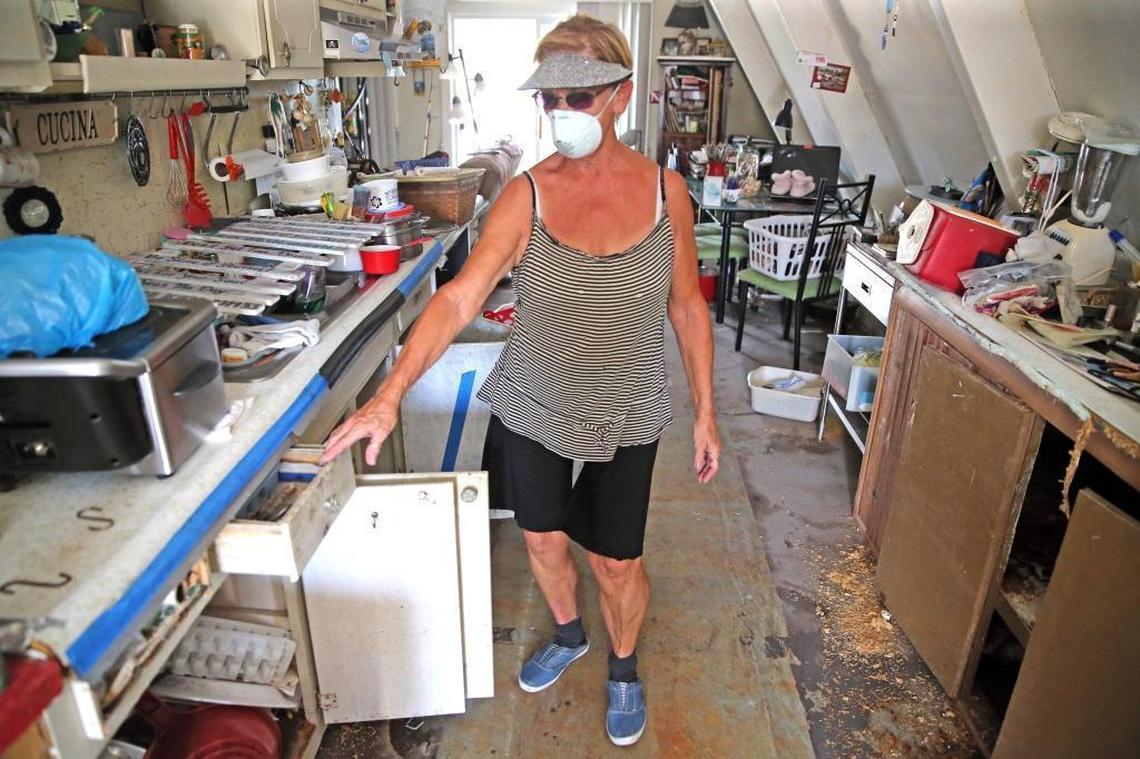 Dee Thorne walks through her home on Big Pine Key, which was partially flooded with storm surge in the wake of Hurricane Irma. She wears a mask to protect herself from the fast-growing mold. They are living in an RV on the lot as they begin to repair the house.