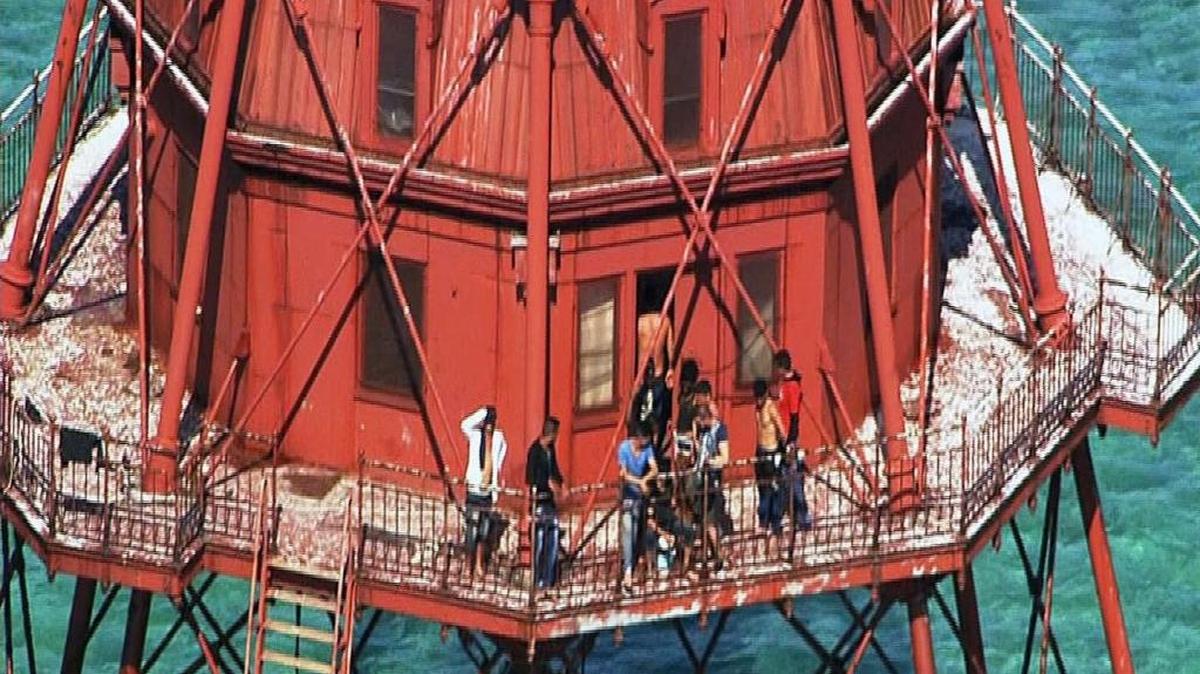 A group of Cubans atop American Shoal Lighthouse off Sugarloaf Key in standoff with Coast Guard on Friday, May 20, 2016. Photos courtesy WSVN.