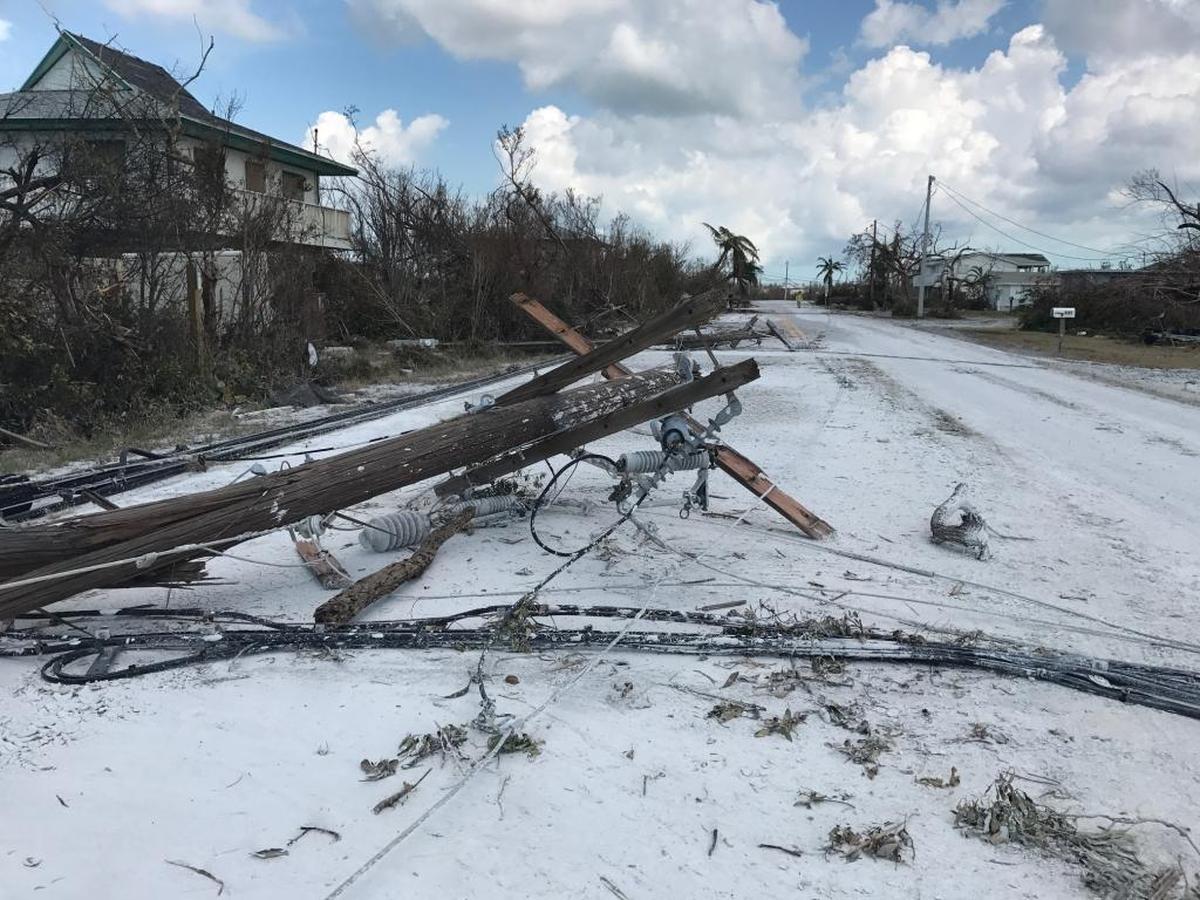 Marl-like mud from the Gulf of Mexico makes a neighborhood road on Little Torch Key look like it’s covered in snow, as downed poles and power lines lie toppled on the ground days after Hurricane Irma hit the area hard on Sept. 10, 2017.