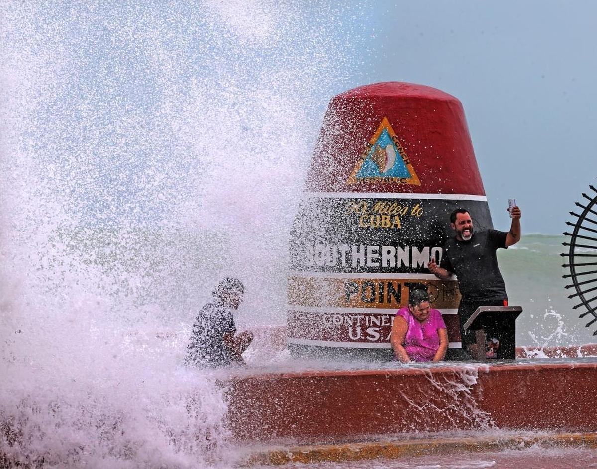 Key West resident Pedro Lara takes selfie in front of the Southernmost Point in the USA monument as waves from Hurricane Irma crashes over the wall Sept. 9, 2017, as the storm approaches.