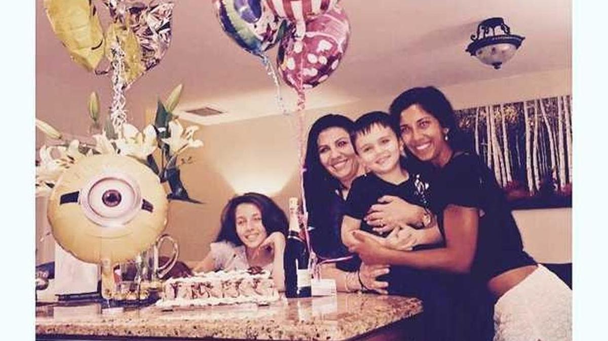
The Petro family (from left) of Mercedes, Aziza, Michael III and Lola celebrates Michael III and Aziza's return to the U.S. with a cake.
