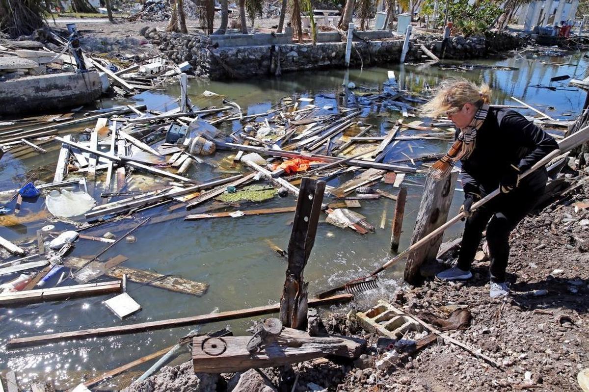Paula Rybacki cleans the canal near her home on Big Pine Key in the Florida Keys on Jan. 18, 2018. Debris from Hurricane Irma filled the canals in the middle keys causing navigation problems and an unsightly view from the homes on the canals.