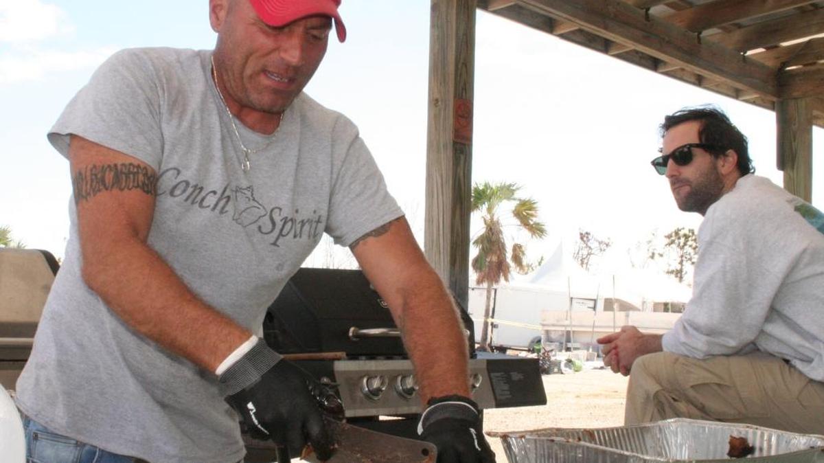 Geno Miletti carves out ribs during a recent cookout on Big Pine Key for locals.