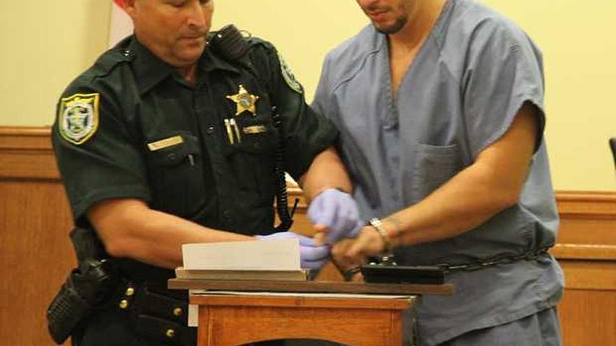 
A Monroe County Sheriff's Office deputy fingerprints Peter Erik Hedvall after Judge Mark Jones handed down his sentence.
