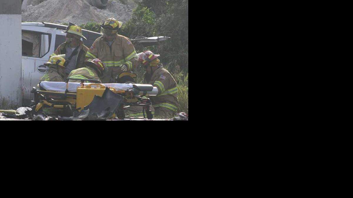 
Islamorada firefighters prepare Miles Didier to be put on a stretcher following a crash in May 2013 that killed Didier's friend, then-22-year-old Kristen Rivera. Didier was sentenced Feb. 24 to 10 years in prison after pleading guilty to drunk driving and DUI-manslaughter charges.

