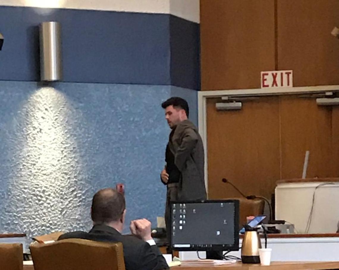 Reid Ogden shows jurors the spot a bullet pierced his abdomen during the attempted second-degree murder trial of Derek David, Friday, Feb. 23, at Plantation Key.