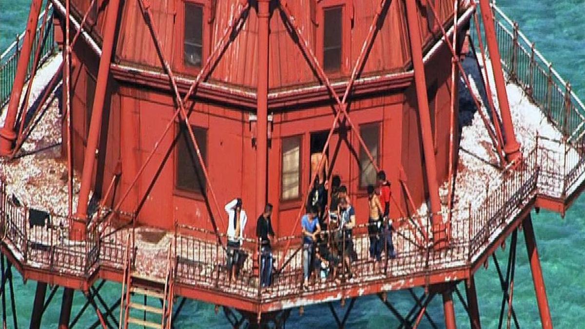 A group of Cuban migrants atop American Shoal Lighthouse off Sugarloaf Key in standoff with Coast Guard on Friday, May 20, 2016.