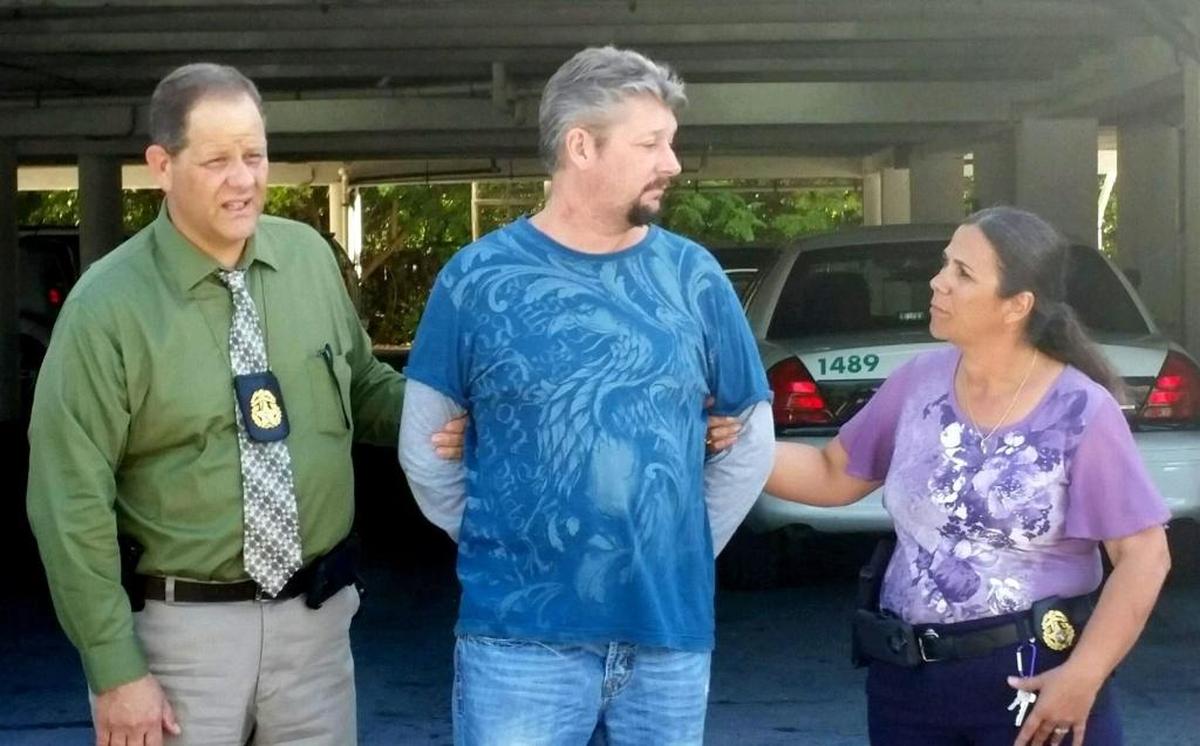 Monroe County Sheriff’s Office Major Crimes Detectives Manuel Cuervo and Dawn Augusto walk with a handcuffed Jeremy Stigler, who was convicted of strangling to death his girlfriend, Jade Dixon, on Nov. 6 or 7, 2016.