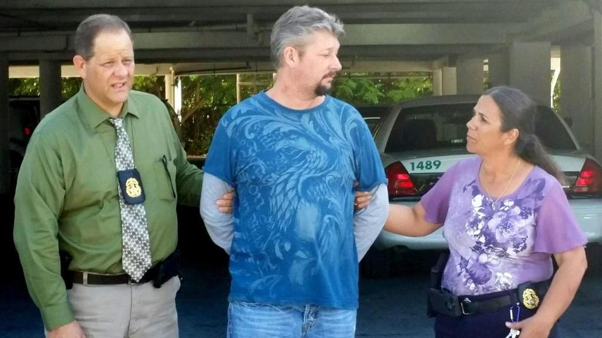 Monroe County Sheriff’s Office Major Crimes Detectives Manuel Cuervo and Dawn Augusto walk with a handcuffed Jeremy Stigler, who was convicted of strangling to death his girlfriend, Jade Dixon, on Nov. 6 or 7, 2016.