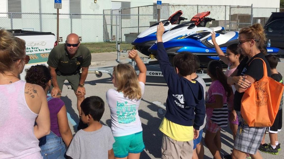Willy Guerra talks to children about boating safety and fishing regulations at the Boot Key Harbor City Marina in Marathon, where he often patrols.
