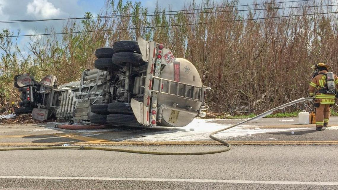 On Friday, Oct 20, 2017, Monroe County Fire Rescue workers clear an accident involving an apparent head-on collision between a fuel tanker going northbound and a line truck at mile marker 21 on the Overseas Highway near Blimp Road on Cudjoe Key.