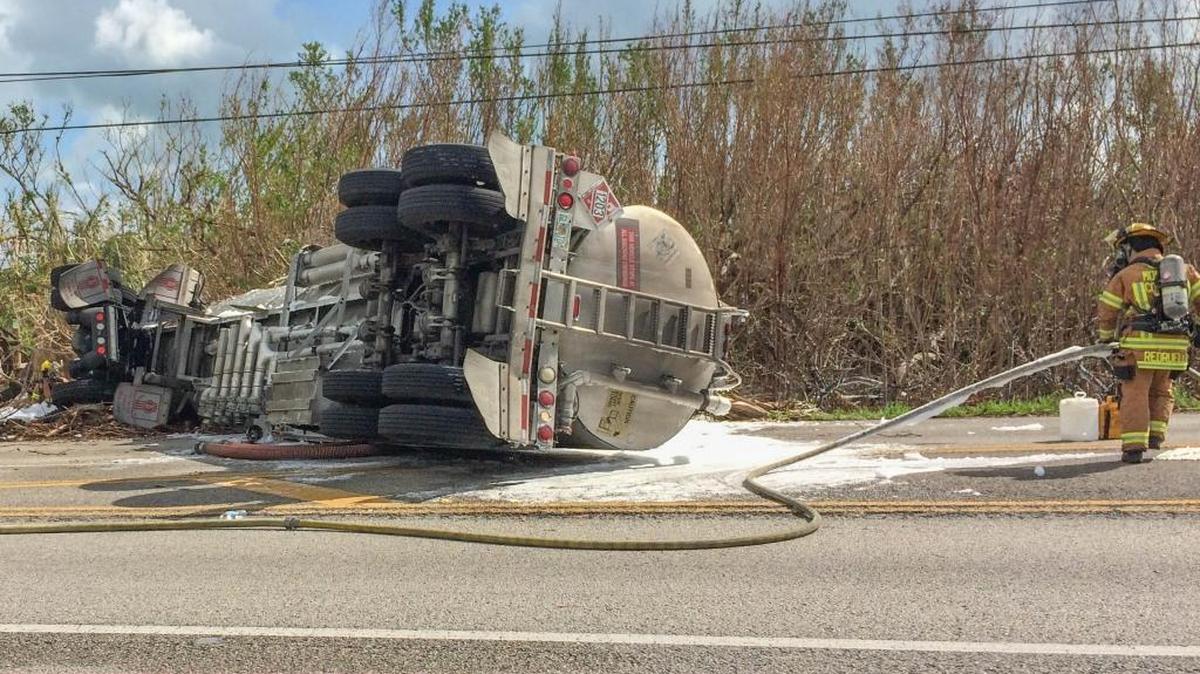 On Friday, Oct 20, 2017, Monroe County Fire Rescue workers clear an accident involving an apparent head-on collision between a fuel tanker going northbound and a line truck at mile marker 21 on the Overseas Highway near Blimp Road on Cudjoe Key.