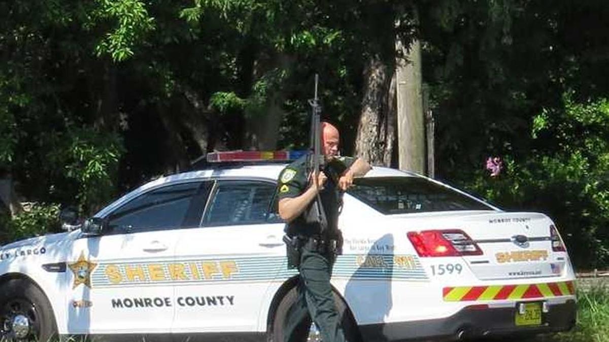
A Monroe County Sheriff's deputy armed with a rifle approaches the Wells Fargo Bank branch in Key Largo, but the Friday incident turned out to be a false alarm. 
