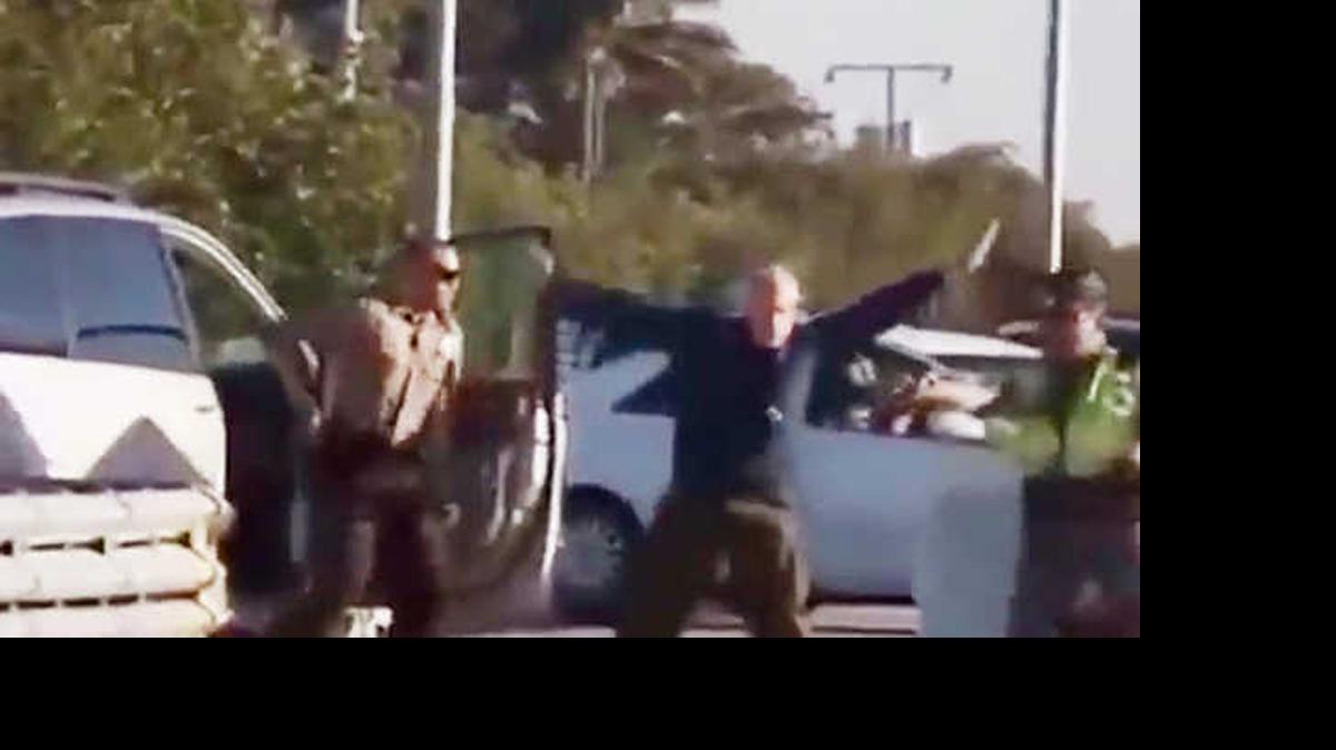 
March Jonathan Freedman has his arms raised moments before being shot with a stun gun by a Florida Highway Patrol trooper.
 

