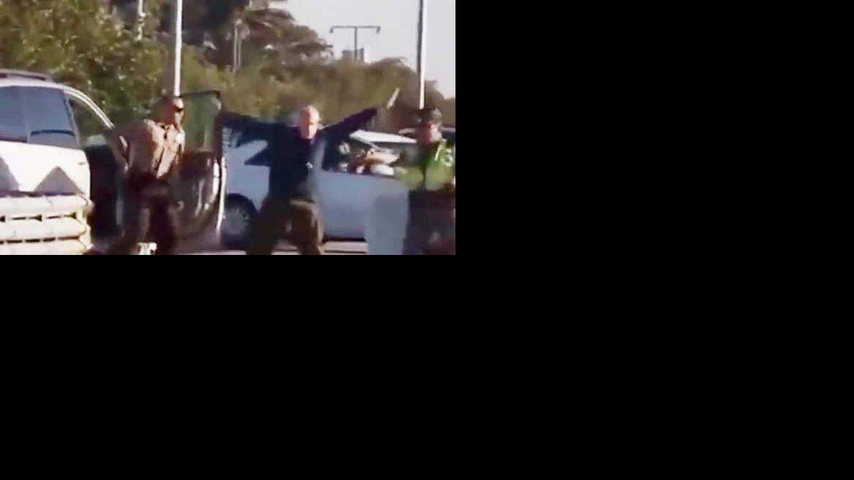 
A screen shot of a YouTube video shows an elderly man with his hands in the air moments before a Florida Highway Patrol trooper shoots him with a stun gun.
