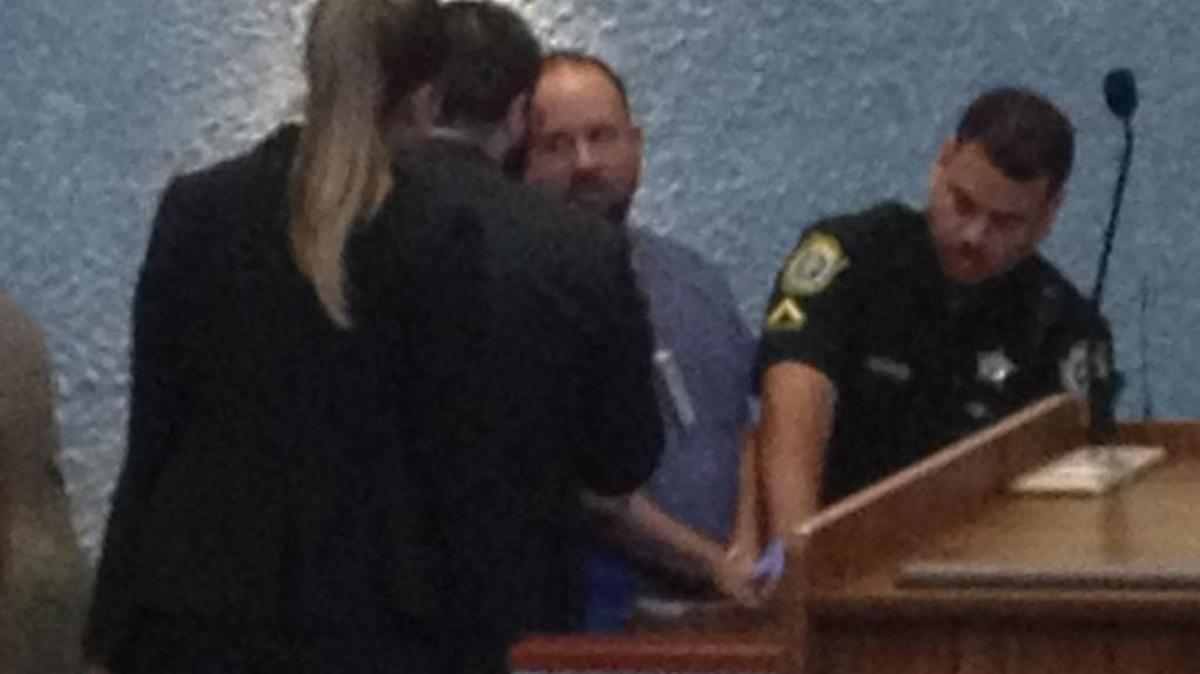 Kristian Demblans talks to his attorneys as a deputy takes his finger prints after Monroe County Circuit Judge Luis Garcia sentenced him to two years in state prison on drug charges Tuesday, March 7.