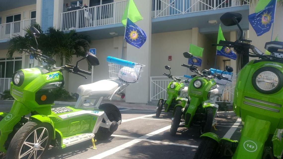 These Zapp electric cycles were waiting for customers outside a North Roosevelt Boulevard hotel on Monday. City code officers say their placement violates zoning law.