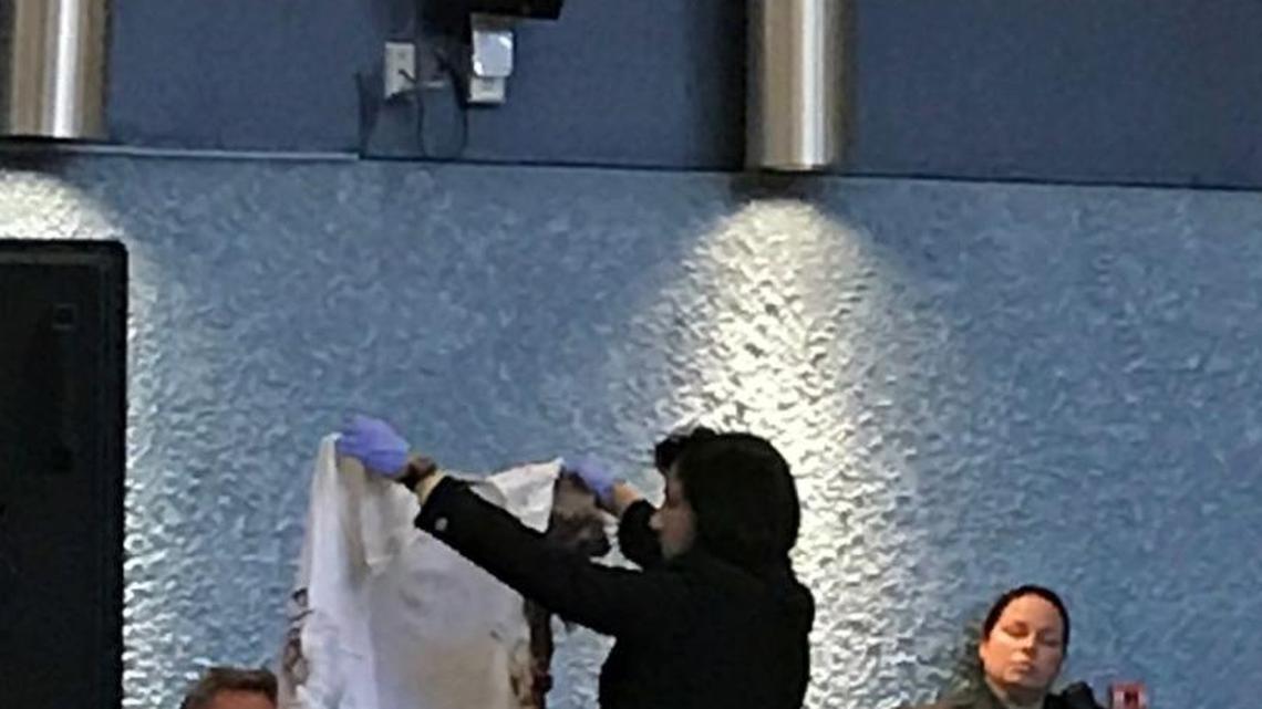 Assistant State Attorney Colleen Dunne holds a blood stained shirt belonging to one of the three men Derek David shot in Key West on March 21, 2016.