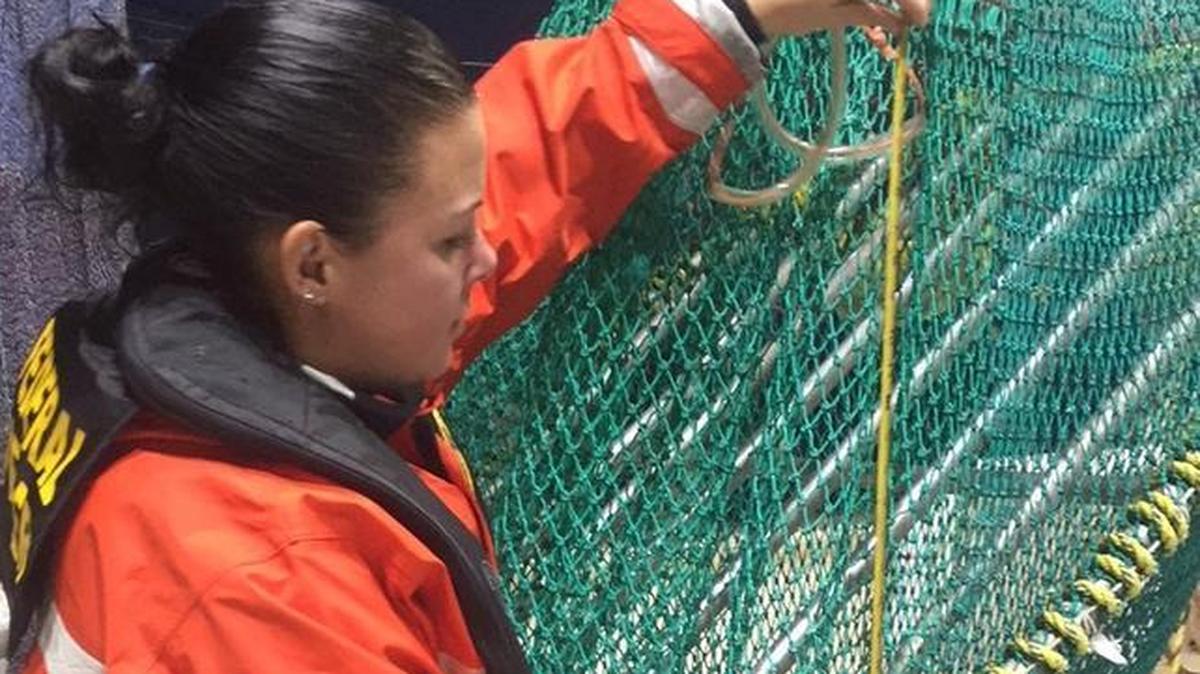 Heather Nicotri, an enforcement officer with the National Oceanic and Atmospheric Administration, measures a turtle exclusionary device for compliance aboard the 68-foot commercial fishing vessel Ronald E. near the Dry Tortugas Shrimp Sanctuary Preservation Area Jan. 12. About 60,000 pounds of shrimp was seized.