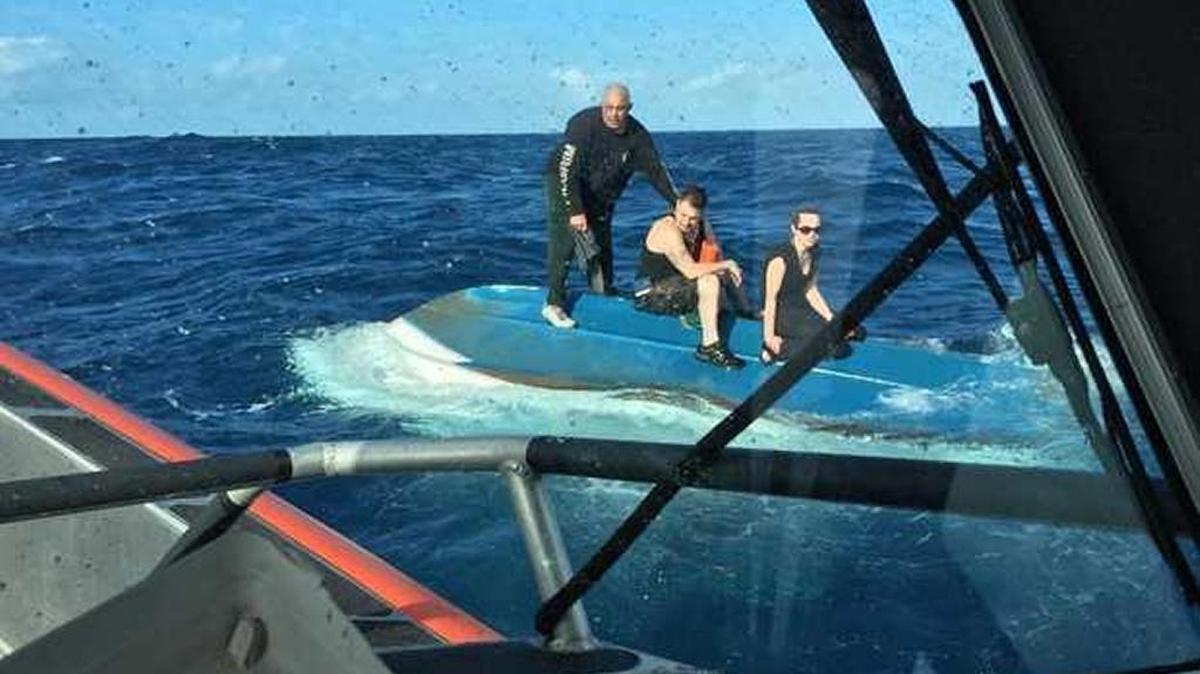 Three people saved from a capsized boat off the Keys.