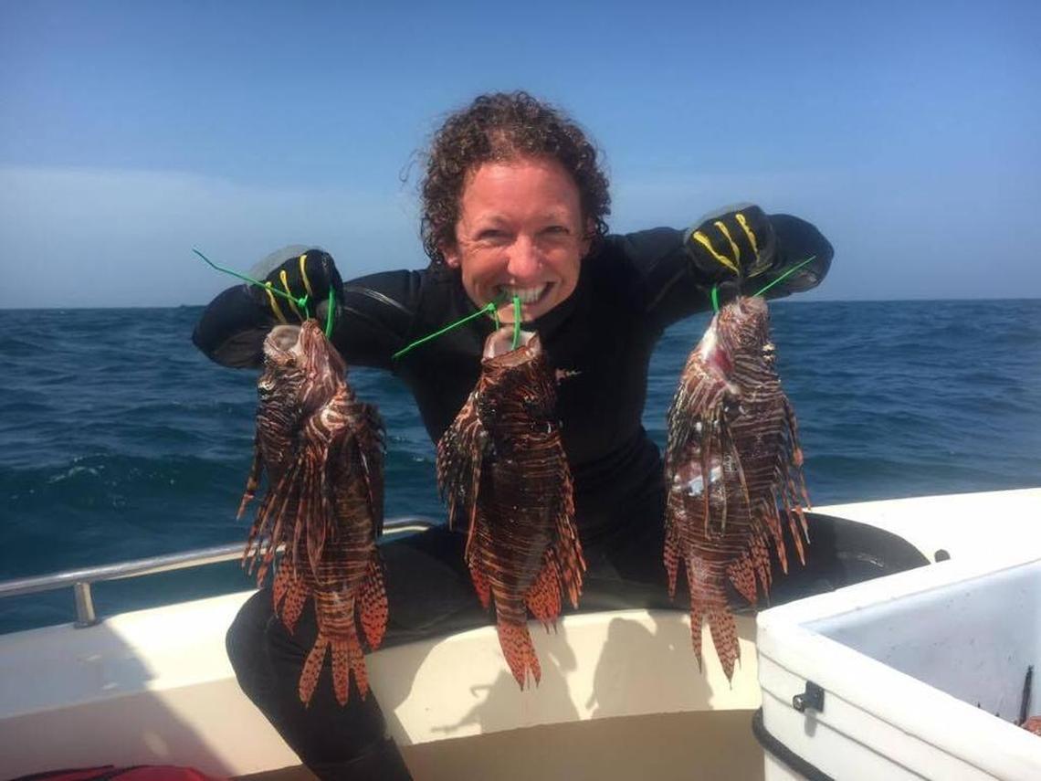 Marathon resident Rachel Bowman poses with three of the more than 900 lionfish caught by her team.